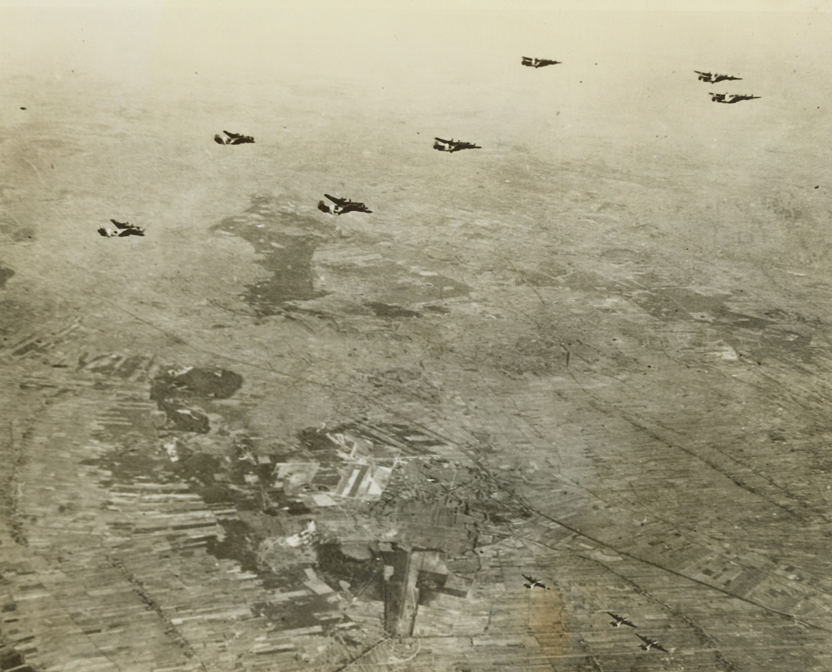 Just Ignored, 1/31/1944. England – Liberator bombers of the U.S. Army 8th Air Force wing their way to their target, Munster, Germany, and contemptuous of Nazi aerial strength, blandly ignore this German airfield enroute to their mission. Credit: U.S. Army Air Forces photo from ACME;