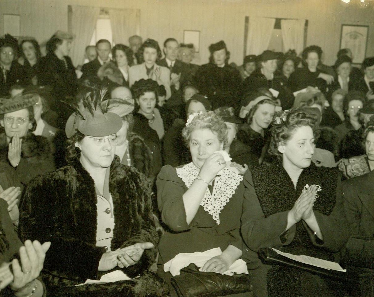 Heroes' Kin Demand Vengeance, 1/30/1944. Maywood, Ill. – Mrs. Fannie Britton (Center) weeps for her son “missing” on Bataan, as American Bataan Clan held indignation meeting at Maywood, Ill., Demanding more materials and men be supplied Gen. MacArthur, following news of Japanese atrocities inflicted on relatives of the Clan. 1/30/44 (Acme);