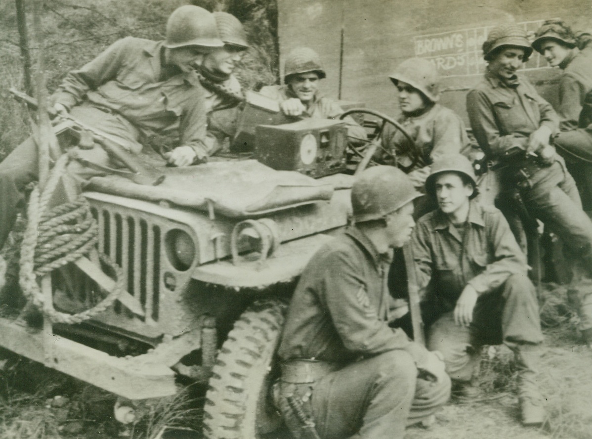 Blow-By-Blow Description of Another Battle, 10/9/1944. GERMANY – chalking up the score on the wall of a captured German Pillbox on the Sigfried Line, These Yanks bend their ears to their radio as they listen to a broadcast of the world Series Game in St. Louis.  In the absence of easy chairs, a jeep serves them well.Credit:  Signal Corp Radiotelephoto from ACME;