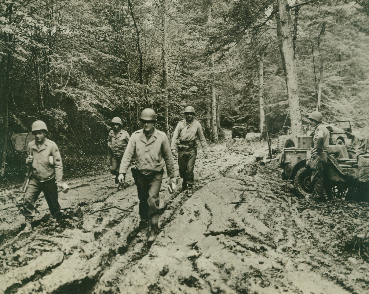 THE SAME OLD COMPLAINT—MUD!, 10/3/1944. FRANCE—As these Yanks plow through the sticky mud in their bivouac area, some of them are reminded of the stories their dads told of the last war. But, when chow is in the offing, it takes more than mud to keep the men away.Credit: U.S. Signal Corps photo from Acme;