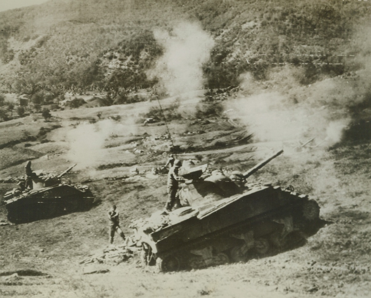 POUNDING NAZIS IN APENNINES, 10/5/1944. ITALY—American tanks pound German positions along the mountainous Gothic Line, as hard-driving Allied troops meet stiff enemy resistance. Credit: Army radiotelephoto from Acme;