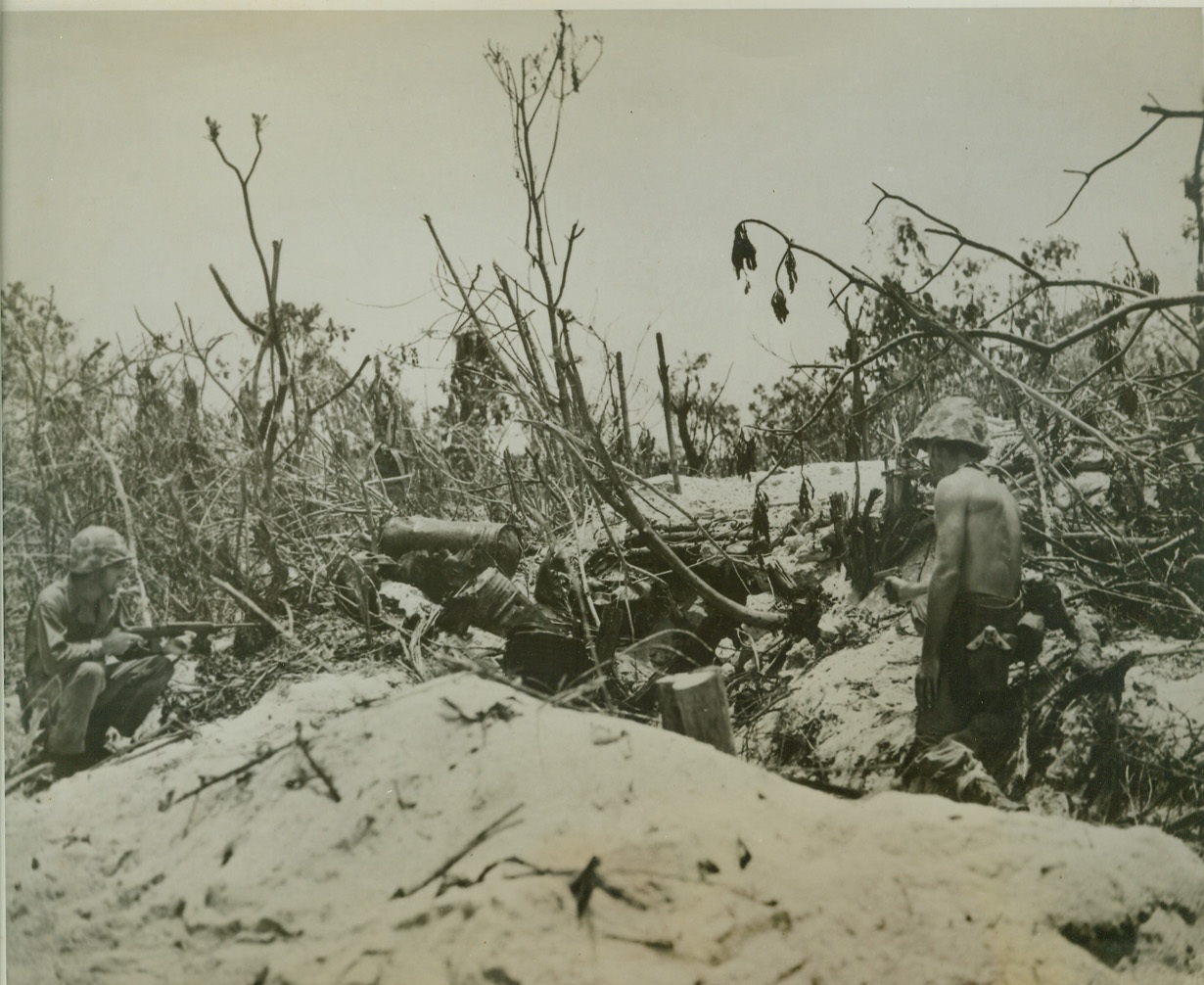 When Japs Get Stubborn, 10/2/1944. PELELIU ISLAND, PALAU -- Cautiously advancing on a Jap pillbox on Peleliu, two Marines order the enemy soldiers inside to surrender. When the Japs refused, the Leathernecks were left with but one alternative -- to blow them out.  Credit: (Marine Corps Photo from ACME);