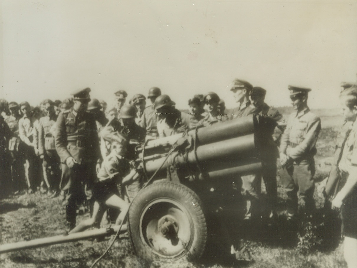 Nazi Youth Bred for Cannon, 10/5/1944. GERMANY – This photo radioed to New York from Stockholm shows a group of German children, ages 9 to 15, being trained by Nazi officers in the proper handling of a multiple rocket gun. Military training for these children in Nazi-ruled Germany is now compulsory. Credit (ACME Radiophoto);