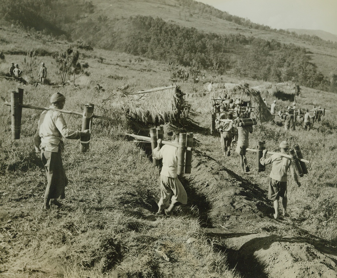 Tengchung Captured from Japs, 10/4/1944.China - - The first city East of Burma to be liberated by the Allies, the ancient Jade center of Tengchung has been captured from the Japs after five bloody weeks of fighting.  Here, Chinese coolies carry 75mm.  Ammunition to Chinese and American guns, emplaced atop the mountains, during the early stages of the fighting.Credit Line (ACME photo by Frank Cancellare for War Picture Pool);