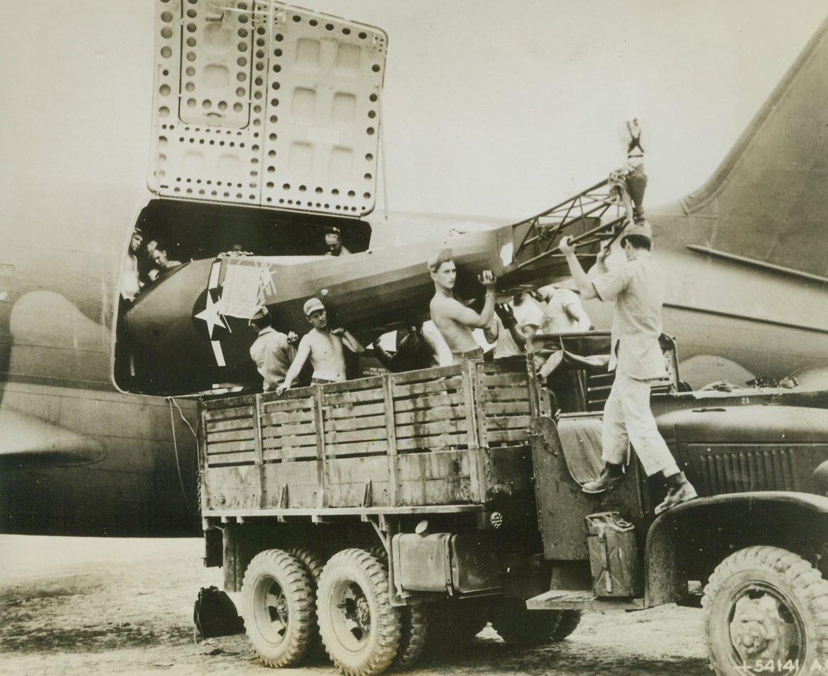 Helicopter Arrives, 10/10/1944. Somewhere in India – The fuselage of a helicopter is unloaded from a transport plane by men of the First Air Commando Group in India.  The little ship was loaded aboard the big transport in the U.S. only a few days before.Credit Line (USAAF photo from ACME);