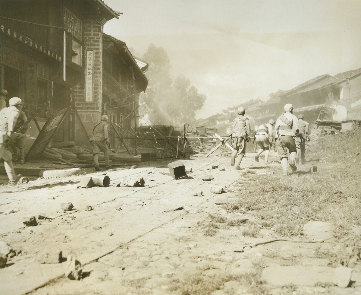 No Title. 10/4/1944. Tengchung, China - - Inching across the rugged, rain-soaked terrain of the Kaoli mountains to face a heavily-fortified Jap force at Tengchung, American-trained Chinese troops captured the ancient Jade center after a bloody, five-week battle.   The first Chinese city on the Eastern side of  Burma to be liberated by the Allies, Tengchung was a battle-seared, rubble-strewn prize when the Chinese moved in.  Approximately 2000 Japs, who were entrenched for a six-month siege, were killed or captured in the battle, which proved the Chinese Army’s ability to use modern weapons and tactics. The U.S. 10th and 14th Air Forces supported China’s fighters in the siege of the principal enemy obstacle to the junction of the Ledo and Burma roads.;