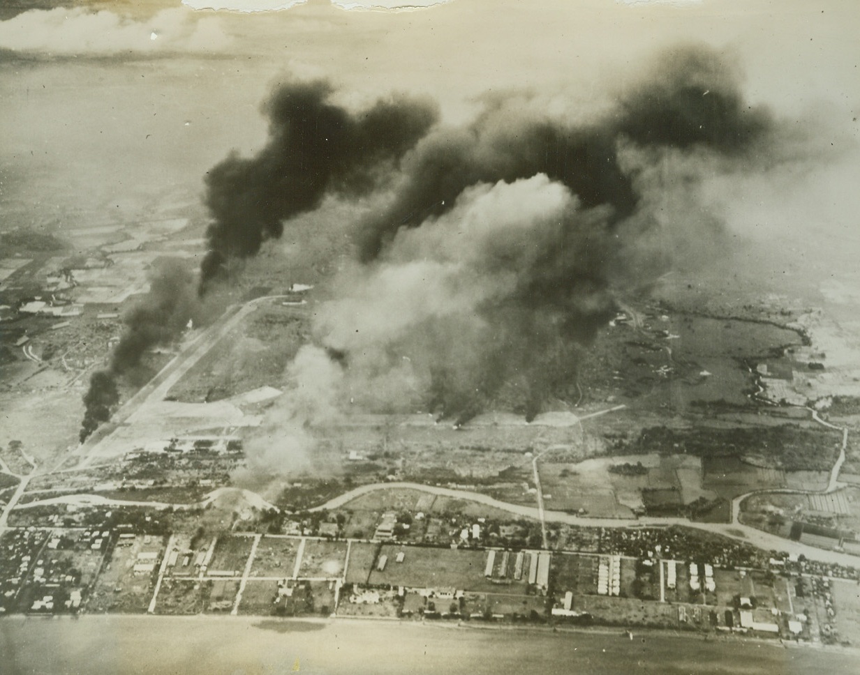NICHOLS FIELD HIT BY AMERICAN PLANES, 10/1/1944. MANILA—Striking at Nichols on Manila Bay where the Japs nearly three years ago caught American planes unprepared on the ground. U.S. Navy pilots of Admiral William F. Halsey Jr.’s Third Fleet, left this scene of destruction after their attacks on Luzon on Sept. 20 and 21st.  169 enemy planes were destroyed in the air and 188 on the ground.  Credit: U.S. NAVY PHOTO-ACME;