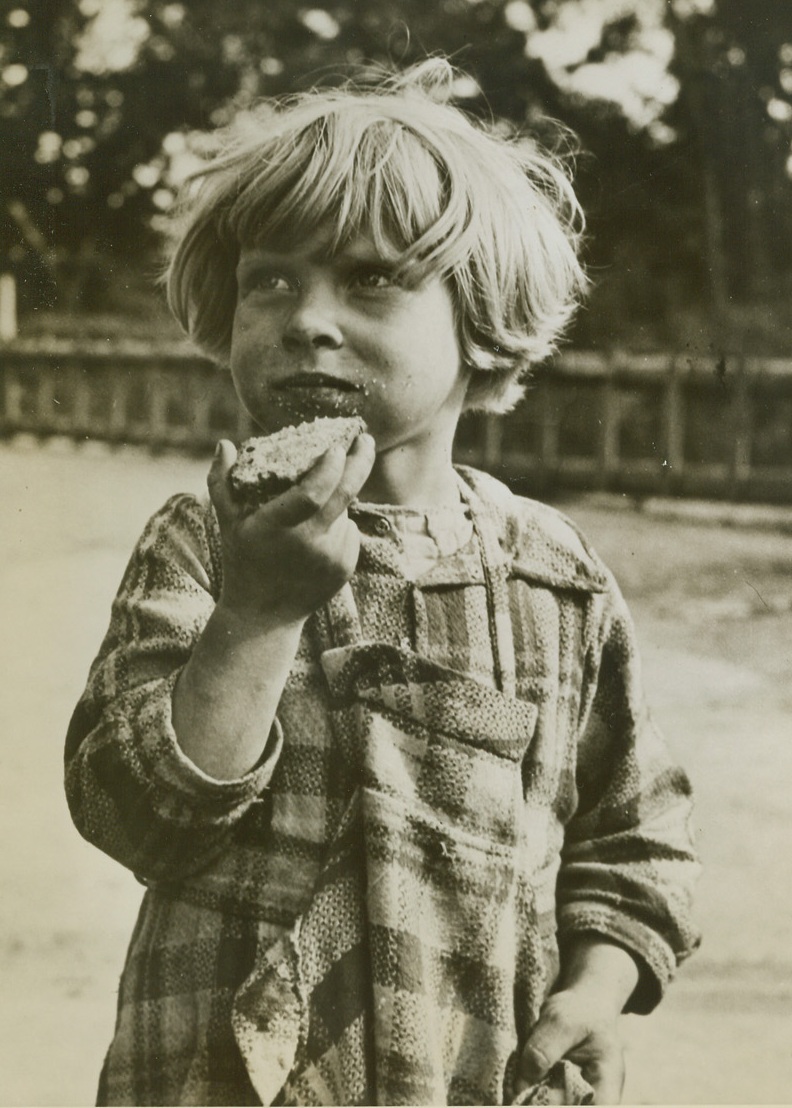 A Child Of War, 10/5/1944. FRANCE - Brown bread, sugar and butter are eaten with relish by this little girl of Dunkirk. A refugee, she is Janine Vilain. Food for needy children took top priority when the town fell to Allied troops. The port itself, where the British evacuated 350,000 soldiers four years ago, is still in enemy hands.;