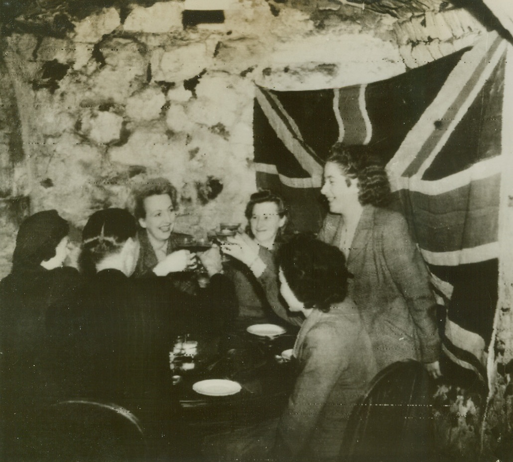 Dover Rejoices, 10/1/1944.Dover, England – Rejoicing over the good news that Dover’s four-year shelling by German cross-channel batteries has ended at last, people of the embattled British town celebrate in a shelter restaurant. Happy civilians raise their glasses in a toast to Canadian troops who silenced the Cap Gris Nez guns across the Channel. Credit: British official photo from ACME;
