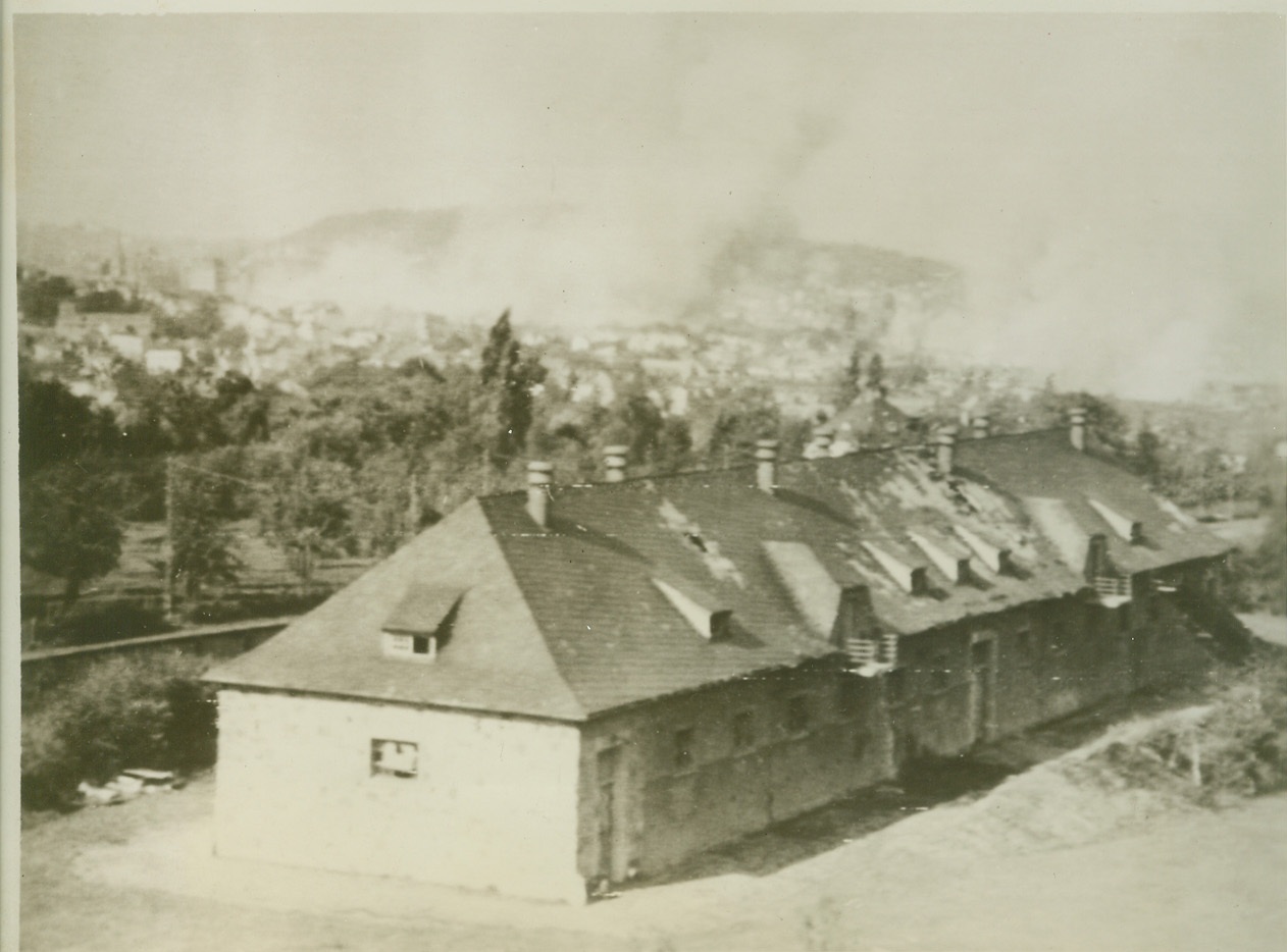 Air War Over Aachen, 10/13/1944. AACHEN, GERMANY – Buildings in Aachen go up in smoke and flames as P-38’s and P-47’s give the German town the once over after the garrison there refused to surrender. Today the Allies were in the outskirts and fighting steadily inward. Credit (Signal Corps Radiotelephoto from ACME);