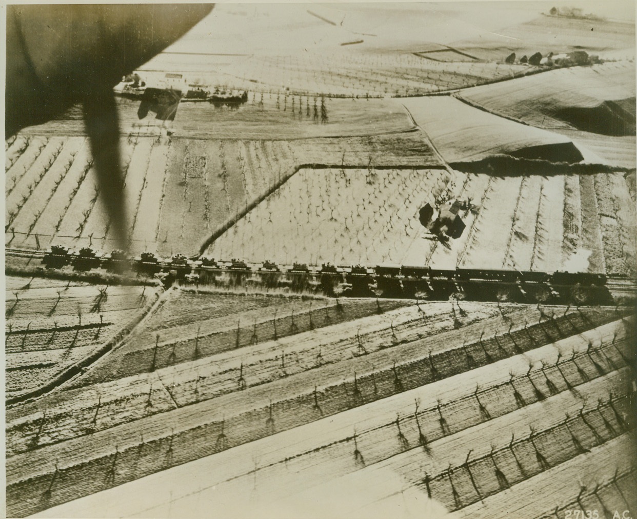 Nazi Tanks Travel, 2/4/1944. A trainload of Nazi tanks moves east of the town of Macerata, near the Adriatic coast of Italy, in this photo, made by a reconnaissance pilot of the U.S.A.A.F. The tanks are Mark IIIs, mounted with assault guns. They were being hauled to reinforce the German units facing the British Eighth Army.  Credit (U.S. Army Air Force photo from AMCE);