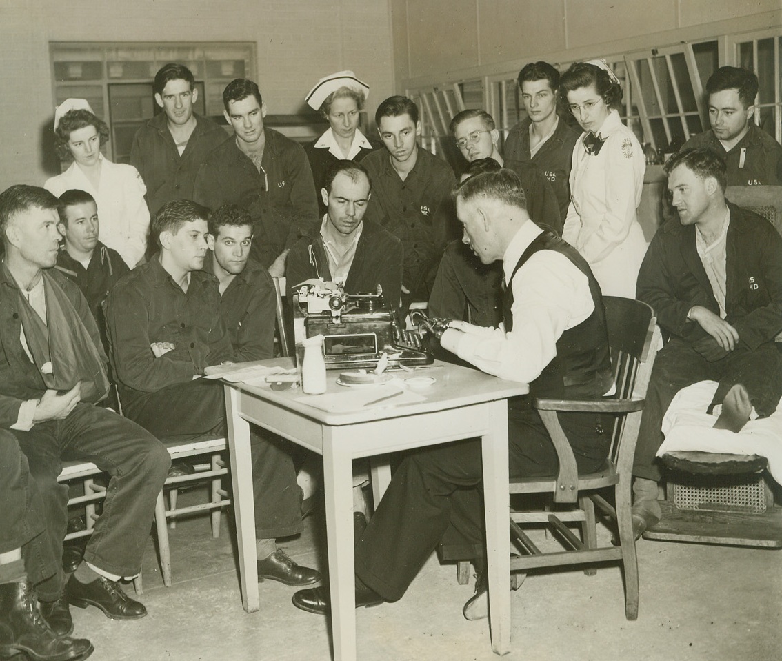 ARTIFICIAL LIMBS DEMONSTRATED, 2/1/1944. WASHINGTON, D.C.—Charles McGonegal, of Sunol, Calif., World War I veteran who lost both arms in combat action, shows his ability to use his artificial hands to a group of present war veterans, similarly afflicted. Demonstration, held under auspices of American Legion, took place in the occupational therapy division of the Army Medical Center, Walter Reed Hospital.Credit: Acme;