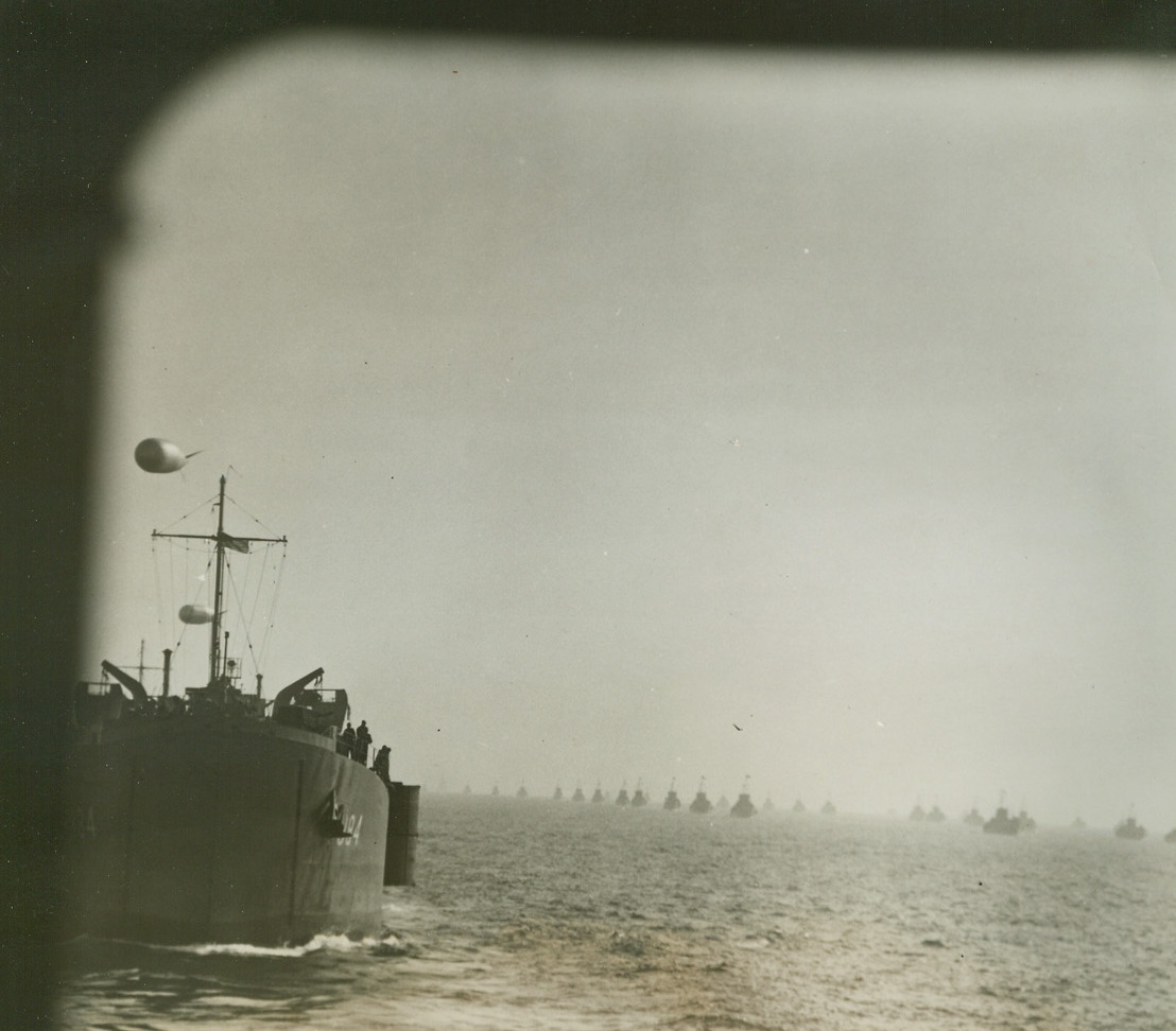 Invasion Armada Heads for Rome, 2/3/1944. This photo, one of the first originals to reach the United States, was taken as the huge Allied invasion fleet headed toward beachheads in the Nettuno-Anzio sector for the drive on Rome. At left (photo above) barrage balloons soar above LSTs (landing ships, tanks), while in center and right background, the sea is covered with invasion craft of various types. (Passed by censors) Credit: ACME photo by Bert Brandt for the War Picture Pool.;