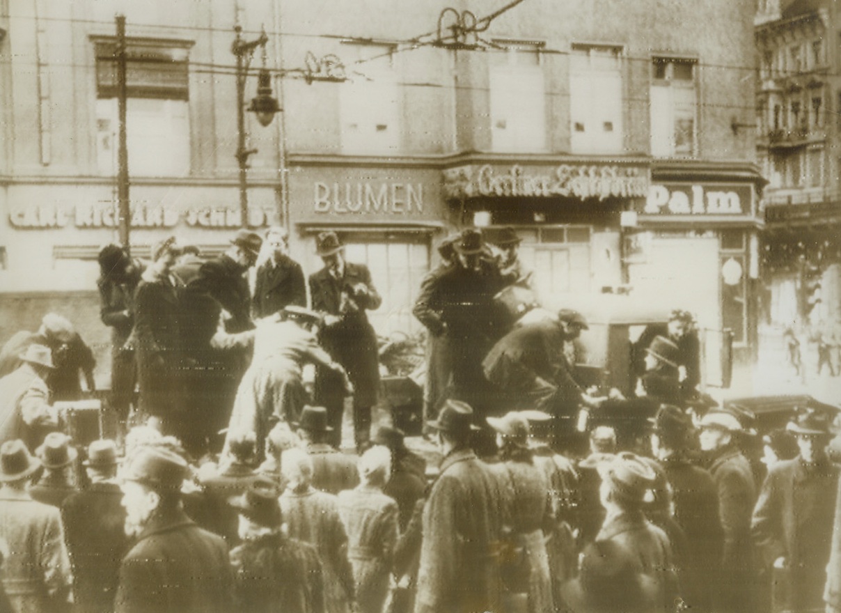 GOING TO WORK, 2/15/1944. BERLIN—This has become a common sight in Berlin ever since the Allies began to pound the German city from the air. Nazi laborers climb aboard a large truck that will take them to work, since bus, subway, street car and elevated lines were destroyed by bombs. But in spite of this means of transportation, many Berliners must walk to their jobs. Photo radioed to New York today (Feb 15th), was obtained through a neutral source. Credit: Acme Radiophoto;