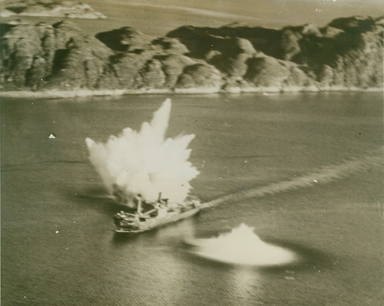 “Ghost” Carrier Packs Real Bombs, 2/9/1944. Two bombs from planes of the aircraft carrier USS Ranger, straddle the German merchantman Saar, during a raid by the American warship on shipping off Bodo, Norway, last October. When last seen, the new type German ship (above) was down by the head. During the raid, which occurred six months after Hitler had decorated one of his U-boat commanders for “sinking” the Ranger, 40,000 tons of enemy shipping were sunk or damaged.Credit Line (U.S. Navy Official Photo from ACME);