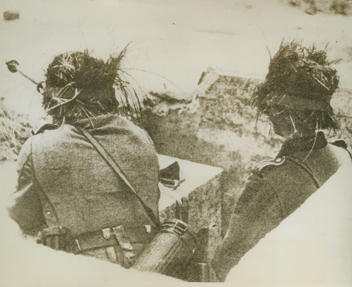 Candidates for Invasion Jitters, 2/10/1944. This photo, just received from a neutral source, shows camouflaged German observers on duty along the “Atlantic Wall”, Nazi defenses along the Invasion Coast of the English Channel. Any day, now, these boys will be in the thick of it when they are confronted by the Allied Invasion Armies under Gen. Dwight D. Eisenhower, Supreme Allied Commander-in-Chief. Credit Line (ACME);