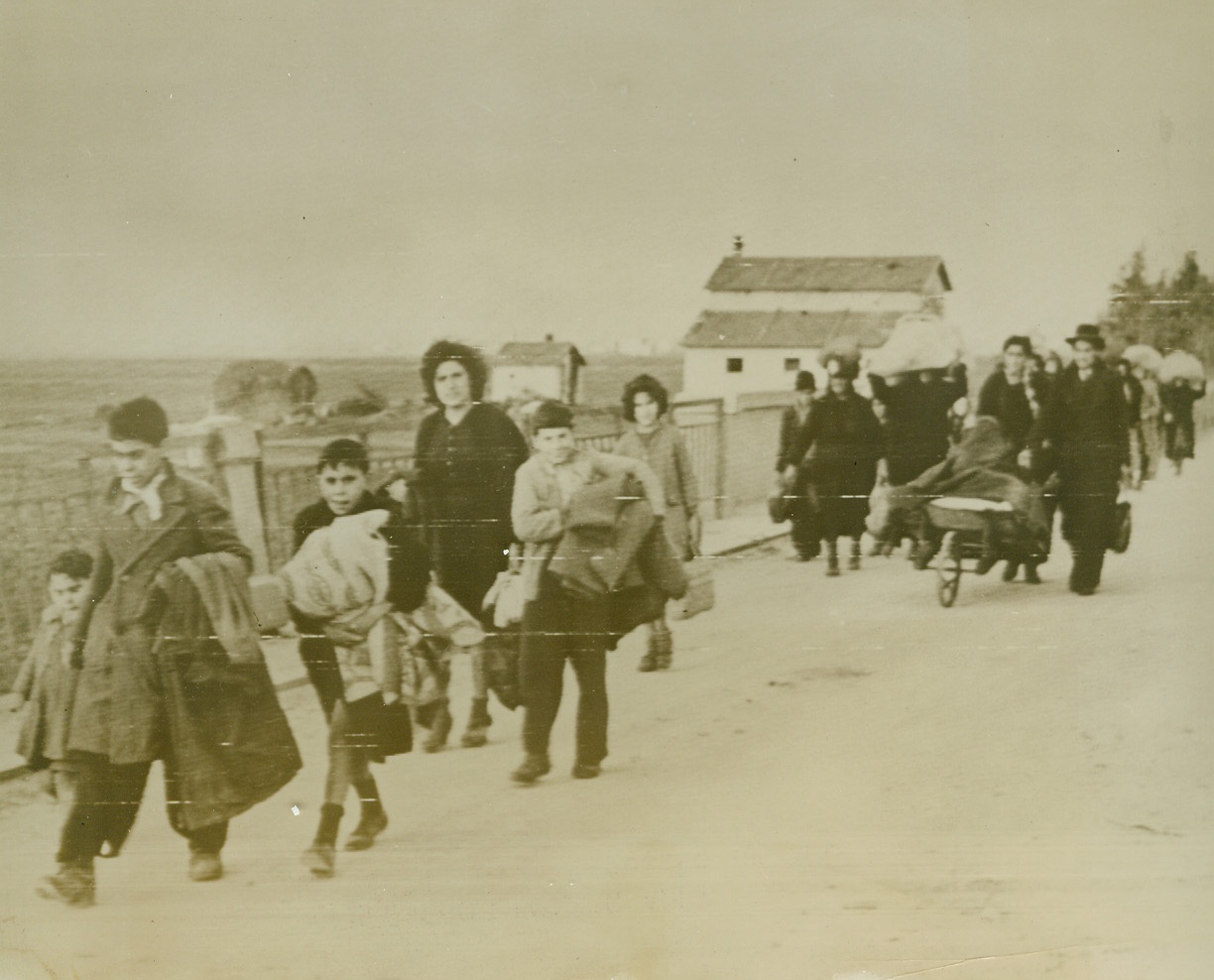 Flee from Former Ally, 2/7/1944. Anzio, Italy – Italian refugees of all ages escape with all their personal effects to Anzio from the German-held territory near Cisterno, where the Fifth Army is battling fiercely for control of the area.Credit (Official Signal Corps Radiotelephoto from ACME);