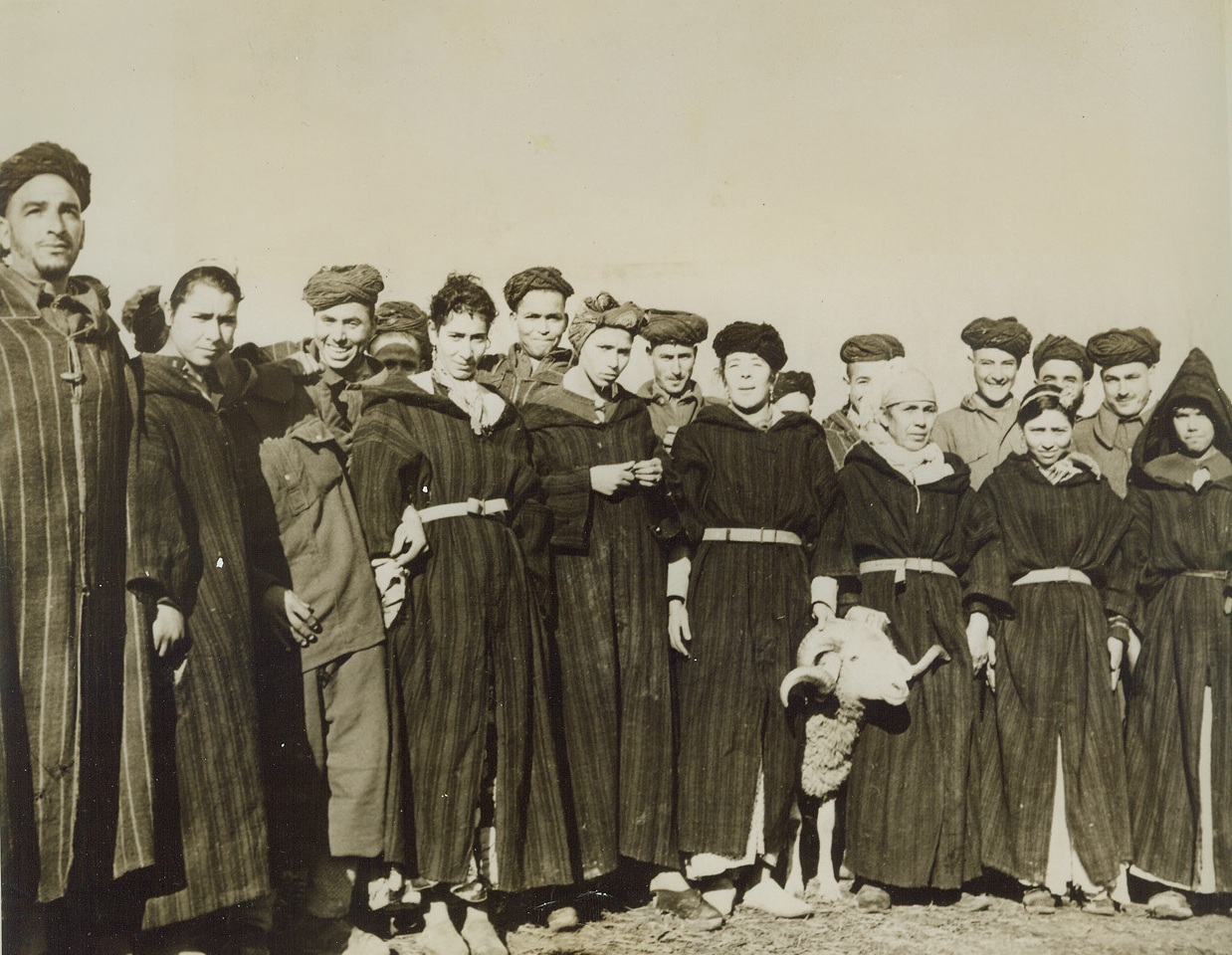 They Follow Their Men, 2/9/1944. ITALY – Unafraid of war and sudden death, these Goum women follow their menfolk wherever they may go in their fight on the side of the Allies. This group of Algerian tribesmen and their women poses at the Goum bivouac near Caserta. The ram is a mascot.Credit Line (ACME);