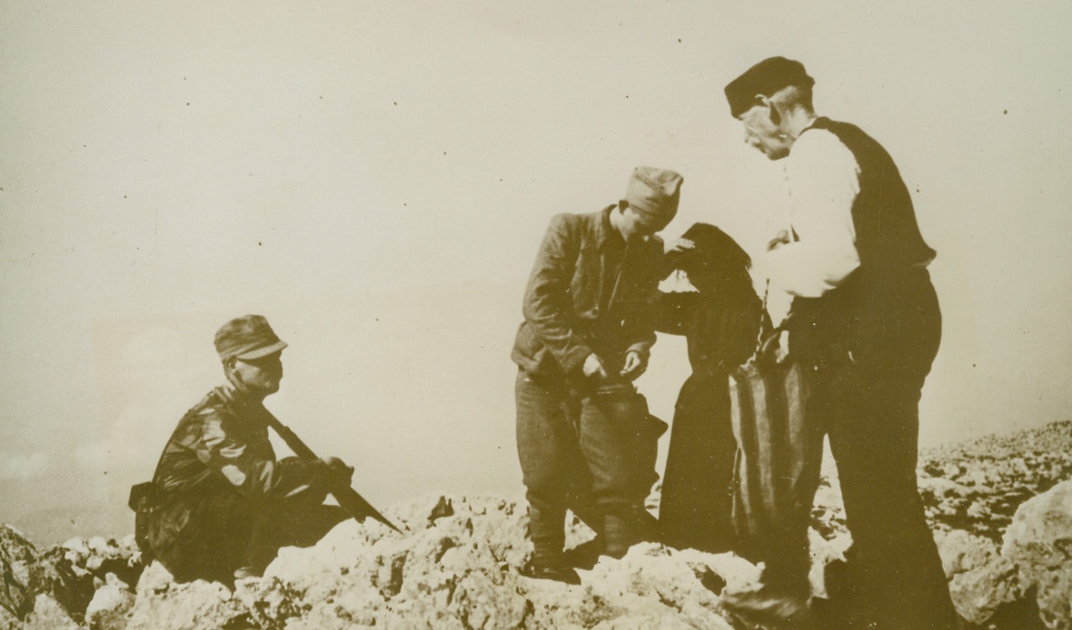 Food for Those Who Fight for Freedom, 2/9/1944. DALMATIA – Two Dalmatian peasants arrive at a mountaintop lookout post, bringing food to Yugoslav partisans stationed there. Too old to join Marshal Tito’s men in their active fight against Hitler, the peasants do all they can to help the small bands battling the Nazis in the Balkans. Credit Line (Acme);