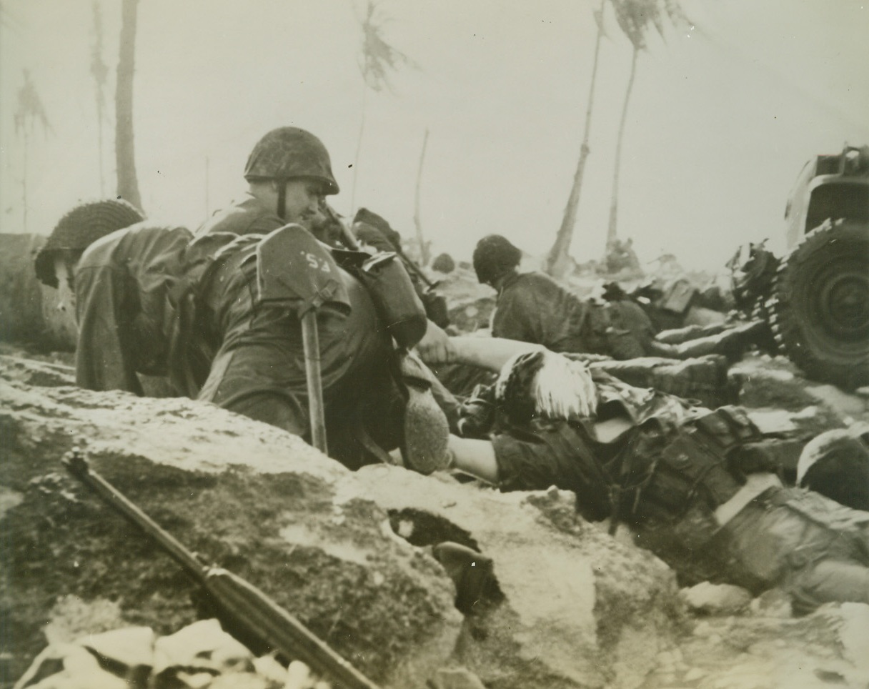 Enitwetok Island Invasion Casualty, 2/25/1944. Eniwetok Island – “Casualties were light.” That phrase from the communiqué gives rise to optimism on the home front but it won’t bring back to life or comfort the next of kin of this Marine being dragged through surf to Coral Beach of Eniwetok Island in Marshalls after Jap bullet killed him as he leaped into surf from landing boat. Did you buy a bond today? 2/25/44 Credit Line (ACME);