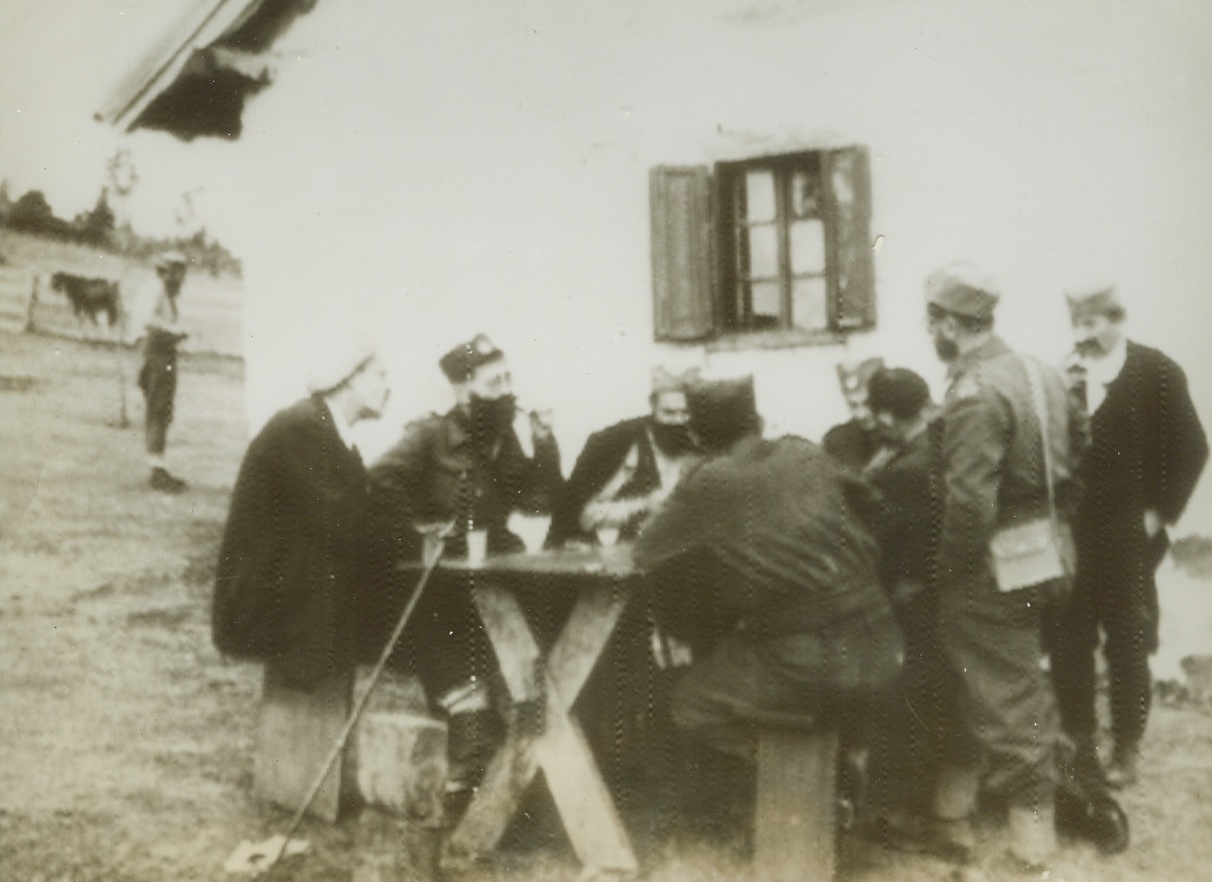 CONFERS WITH BRITISH IN YUGOSLAVIA, 2/19/1944. SOMEWHERE IN YUGOSLAVIA—General Draja Mihailovitch (center), leader of Chetnik soldiers who is minister of War to King Peter’s government-in-exile, confers with two British liaison officers, “somewhere in Yugoslavia.” Photo flashed from Stockholm to New York, today. Credit (ACME Radiophoto);