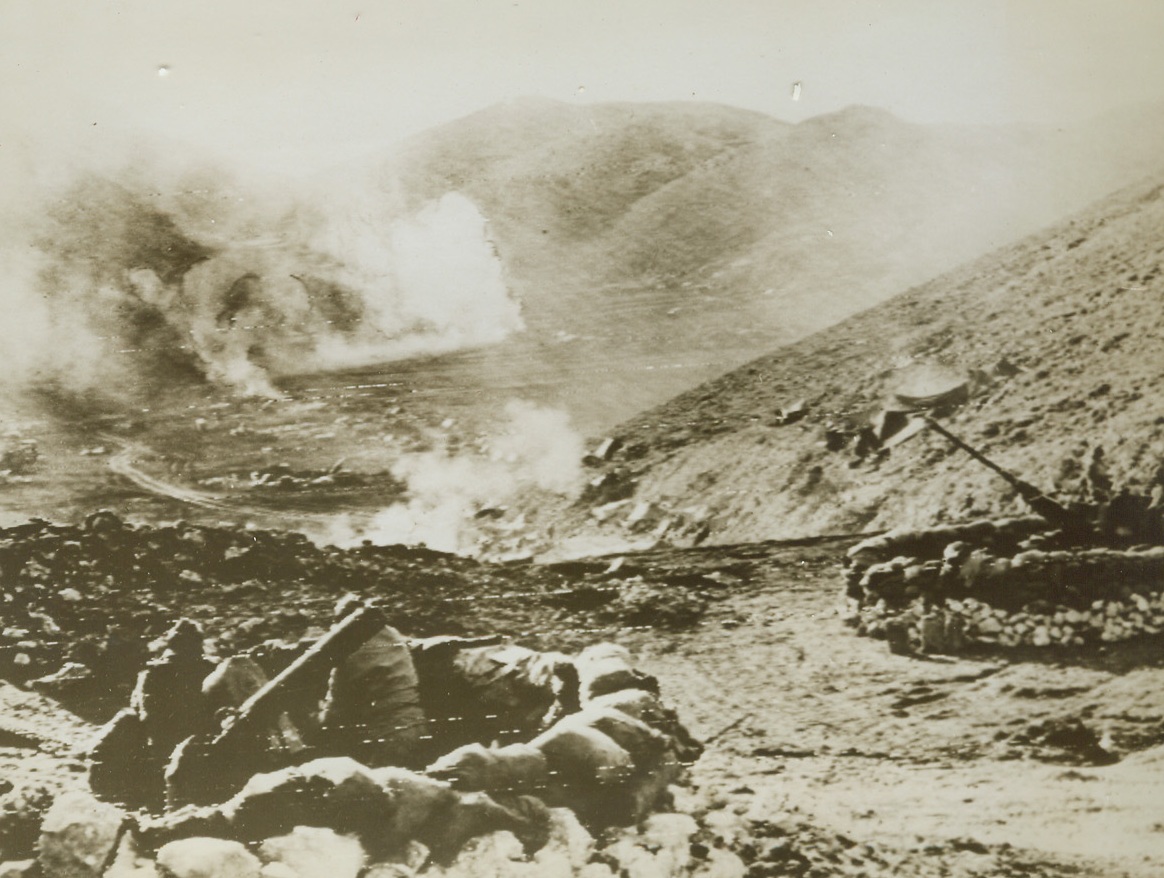 CLOSE CALL, 2/7/1944. NEAR S. ELIA, ITALY: Despite closely bursting German shells, American and French anti-aircraft units stand by their guns in the valley near S. Elia, Italy. Credit (Official Signal Corps Radiotelephoto from ACME);