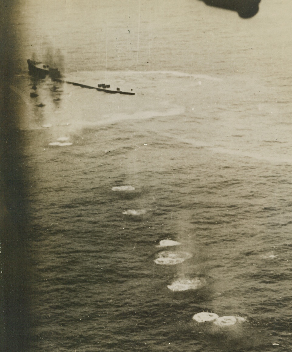 Marked for Destruction, 2/2/1944. This photo, released by the Navy Department in Washington today, shows a U.S. Navy Liberator Bomber (PB4Y) starting a run on a Jap oil barge off New Ireland, in the Pacific. A string of splashes leading up to the enemy craft mark machine gun hits “marching” up and across the barge. Black smoke marking fires and a spreading oil slick around the craft attests to the success of the attack. The barge was later sunk by bomb hits. Credit: U.S. Navy official photo from ACME;