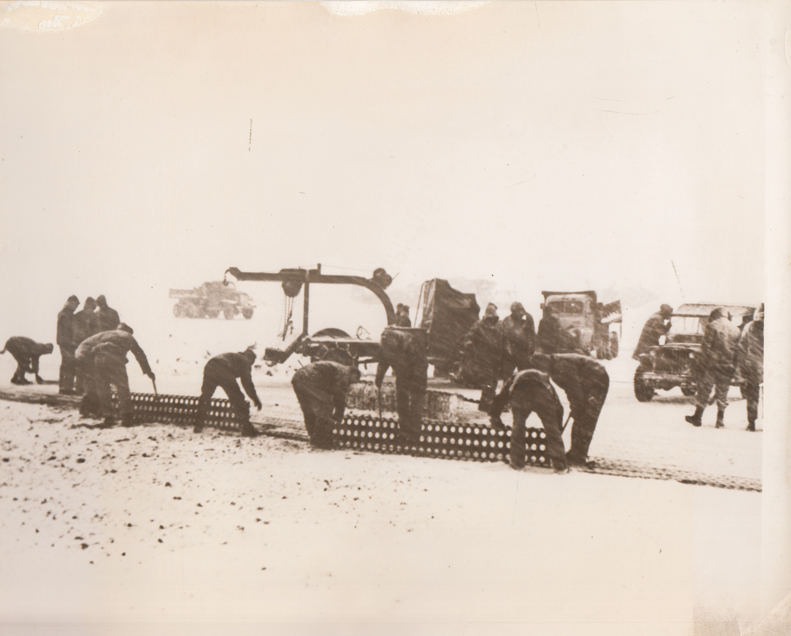 Snowbound Springboard to Paramushiru Aleutians, 2/8/1944. Seabees work through a mile-a-minute gale at an Aleutian base from which American planes take off to bomb Paramushiru, key Jap stronghold in the Kuriles.;