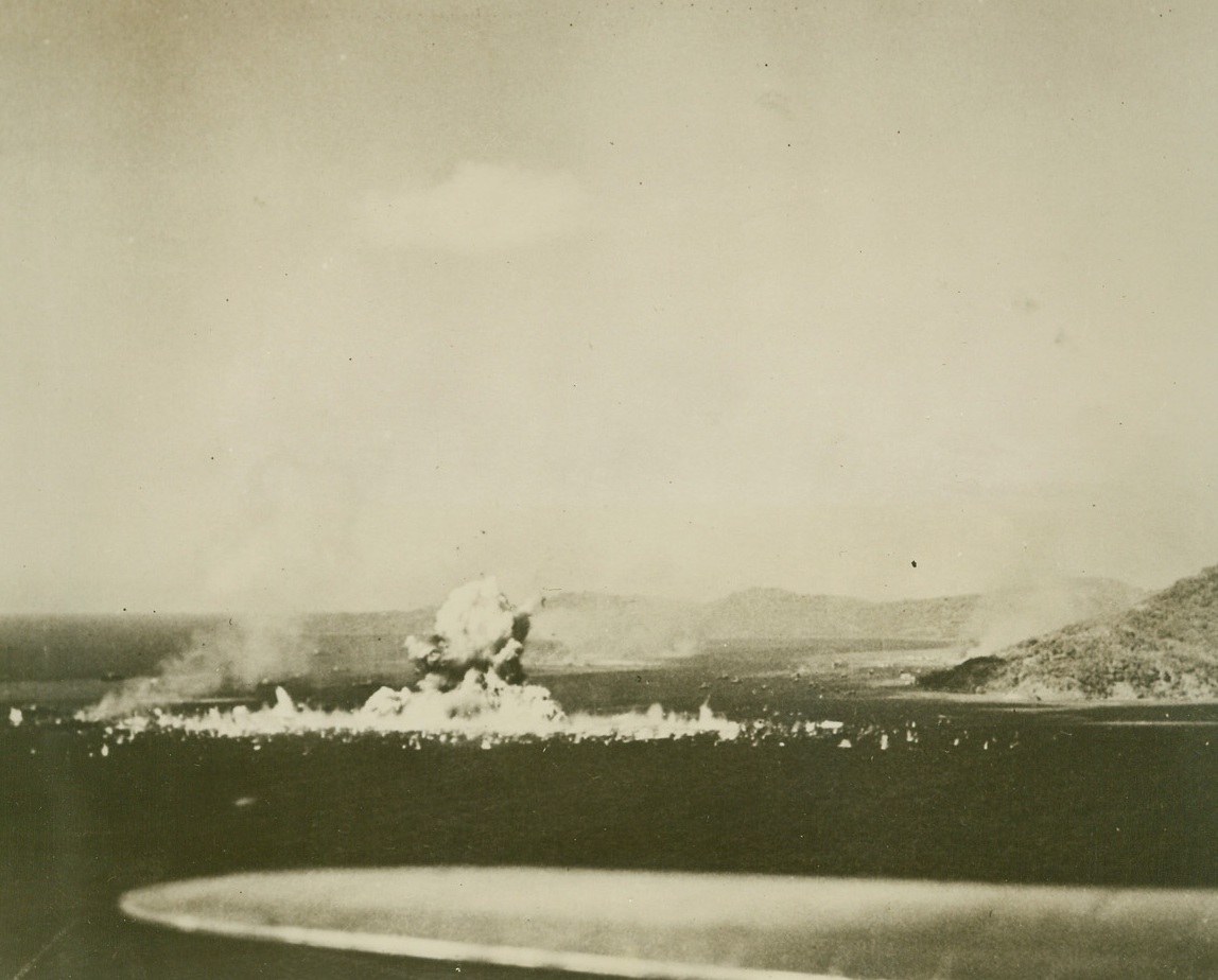 Nip Ship Does “Disappearing Act”, 2/28/1944. Truk—In one huge gout of smoke and debris, a Japanese ammunition ship is blasted to pieces as it receives a direct hit from a U.S. Navy dive bomber, one of the carrier-based aircraft taking part in the recent attack on the Nip Pacific stronghold of Truk, in the Caroline islands.  The American plane scoring the hit was caught in the blast and destroyed during the raids by a huge U.S. Task force on Truk Feb 16-17, 23 Jap ships were sunk, six probably sunk, and 11 damaged.Credit Line (U.S. Navy photo from ACME);