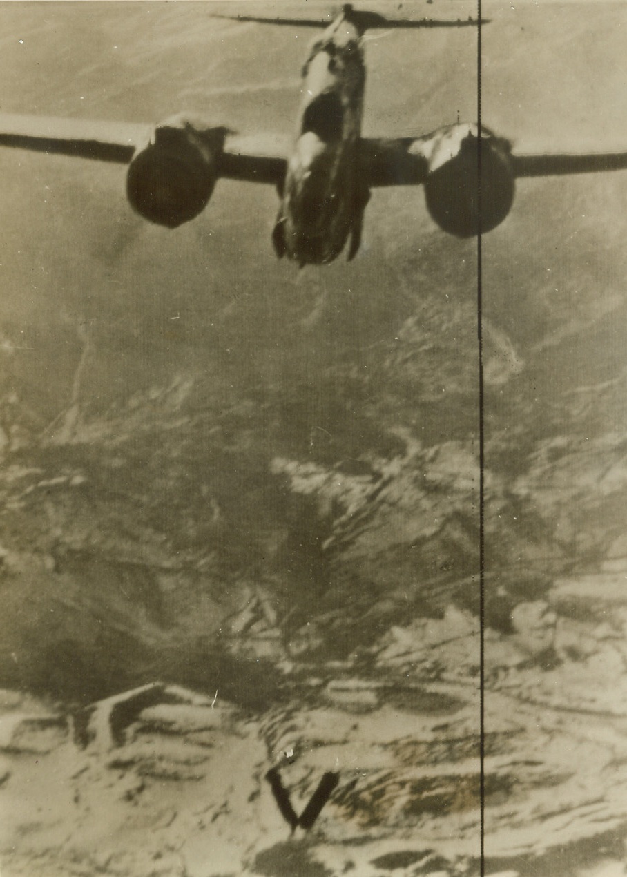 Sign of the Times, 2/1/1944. This photo, flashed to New York tonight by radio from Algiers, shows two bombs (bottom center) forming a perfect “V” – the victory sign – as they fall from the bomb bay of a Baltimore bomber of the RAF, on their way to the target, communications centers along the Rome-Pescara road in Italy.  Today, it was announced that British and American troops have launched their first offensive since the landing on Anzio beaches 10 days ago, and have driven to the outskirts of Campo Leone, only 15 miles Southeast of Rome. Credit line (ACME radio photo);