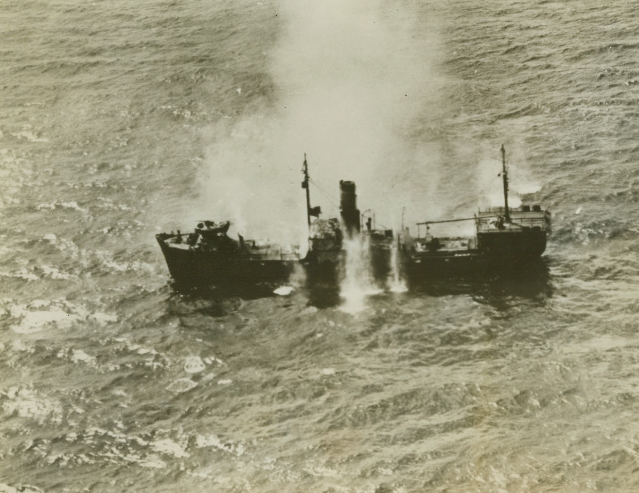 Special Delivery to Davy Jones, 2/19/1944. Engebi Island—A Jap medium size freighter is caught in an exploding net of bomb bursts, as Navy carrier planes send enemy supplies to the bottom of the sea, off Engebi Island, Eniwetok Atoll in the Marshalls. On a return trip to the Northwest Marshall Island Group, Navy fliers softened Eniwetok as Army and Marine assault troops stormed ashore. Credit: US Navy photo from ACME;