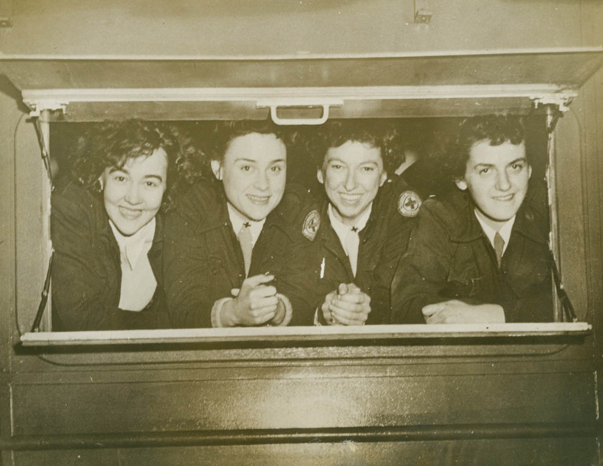 Clubmobile Gals, 2/19/1944. Here are the girls who man the Clubmobile (left to right): Dorothy “Mike” Myrick, 24, of Whiting, Ind; Katharine “Tatty” Spaatz, 22, “homeless” daughter of the Air Forces; Julia “Dooly” Townsend, 28, New York City; Virginia “Ginny” Sherwood, captain of the crew, 24, of Portland, Ore. The girls have named their mobile canteen the “North Dakota.” Credit: ACME.;