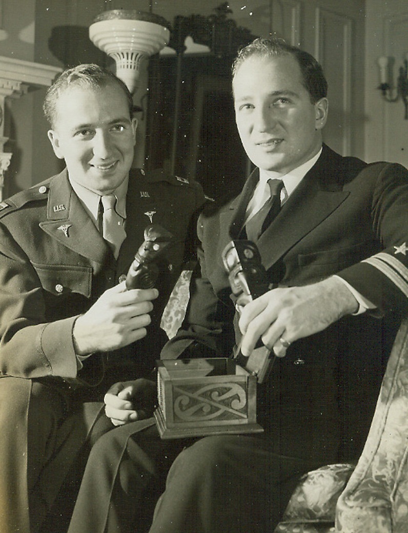 Identical Twins Get Identical Leave, 2/24/1944. Chicago—Identical twins with comparable rank got identical leave from Army and Navy and returned to their home in Chicago to see each other for the first time in three years. Capt. Richard Cook (left) of the Army medical corps has been stationed in Camp Hahn, Calif., and is en route to a new assignment. Lt. Robert Cook was on a boat in Pearl Harbor at the time of the Jap sneak attack and has been in the Pacific since that time. Only change they noted at their reunion is that Robert has lost some hair and Richard has put on some weight.Credit: ACME.;