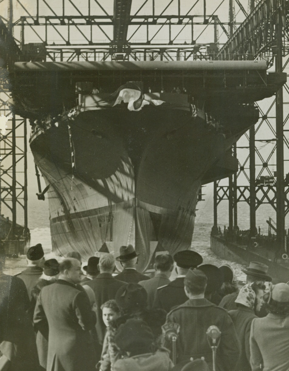 New Carrier for Uncle Sam, 2/7/1944. Newport News, VA. - Named after Fort Ticonderoga, the U.S. Navy’s newest Aircraft Carrier, the USS Ticonderoga slides down the ways at the Newport News Shipbuilding and Drydock Co., after launching ceremonies today. Miss Stephanie Sarah Pell, who christened the warship, had to take two swings at the huge bow, before the champagne bottle smashed against the vessel’s sides. The Ticonderoga is the sixth carrier of the Essex Class to be launched by the yard. It is the fourth ship in the history of the U.S. Navy to bear the name. Credit: ACME;