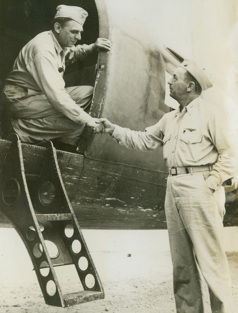 Adieu, 2/11/1944. Raymond E. Clapper, left, newspaper columnist for the Scripps-Howard Newspaper Alliance and Radio Commentator, bids goodbye to Major General Ralph J. Mitchell, right, Commander of Marine Air Units in the Solomons; as he took off from Munda Airfield. Mr. Clapper died in mid-air crash while on a tour of the South Pacific Bases and the war zones. Credit: U.S. Marine Corps photo from ACME;