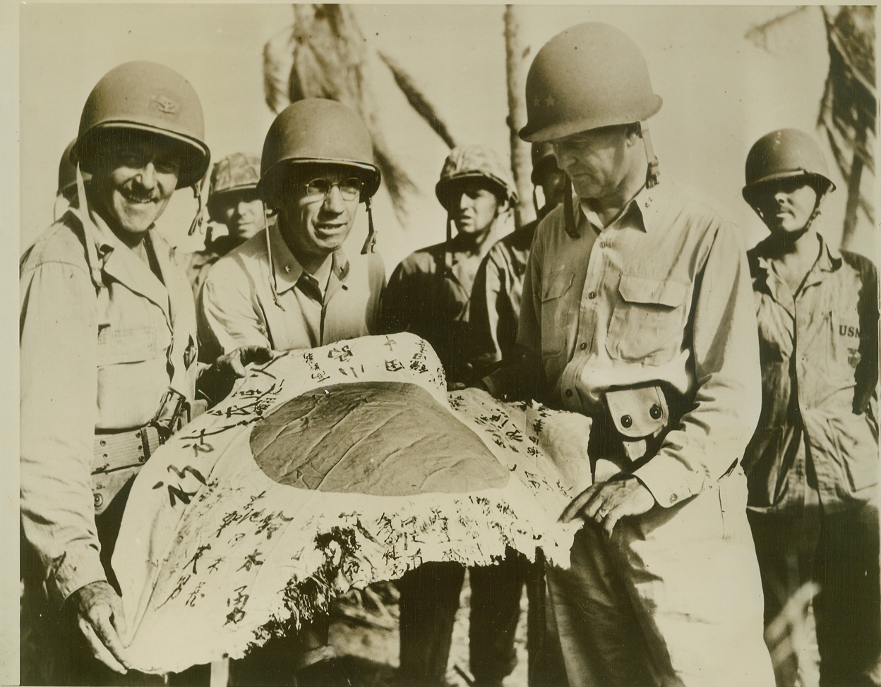 Led Forces at Eniwetok, 2/28/1944. Eniwetok—Here are the men that led the forces capturing Eniwetok Atoll, latest conquest of U.S. attackers in the Marshall Islands. Shown with the Jap flag captured in the fighting, are: (left to right), Col. Russell G. Ayers, Brig. Gen. Thomas E. Watson, and Rear Admiral H.W. Hill. They commanded Army, Navy, and Marine Corps elements in the fighting.  Credit: U.S. Coast Guard photo from ACME.;