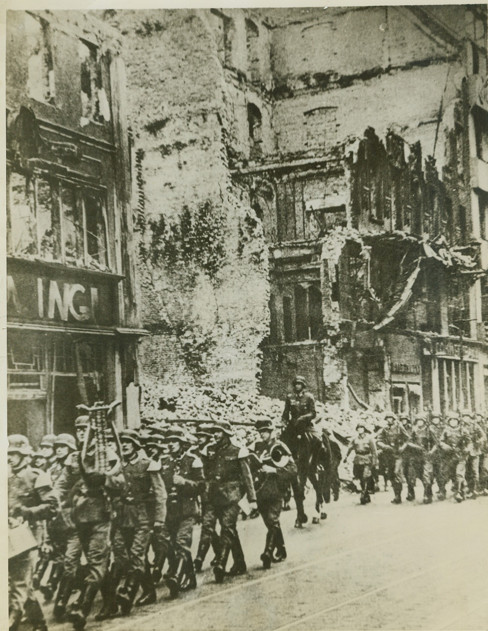Morale Builders, 3/30/1944. Berlin – Trying to boost the morale of war weary Berliners, the victims of constant Allied bombings of that German city, a unit of the Reichswehp parades past blasted buildings through the shattered streets of Berlin. Martial music and the roll of drums accompany the marchers.  Credit: (ACME);
