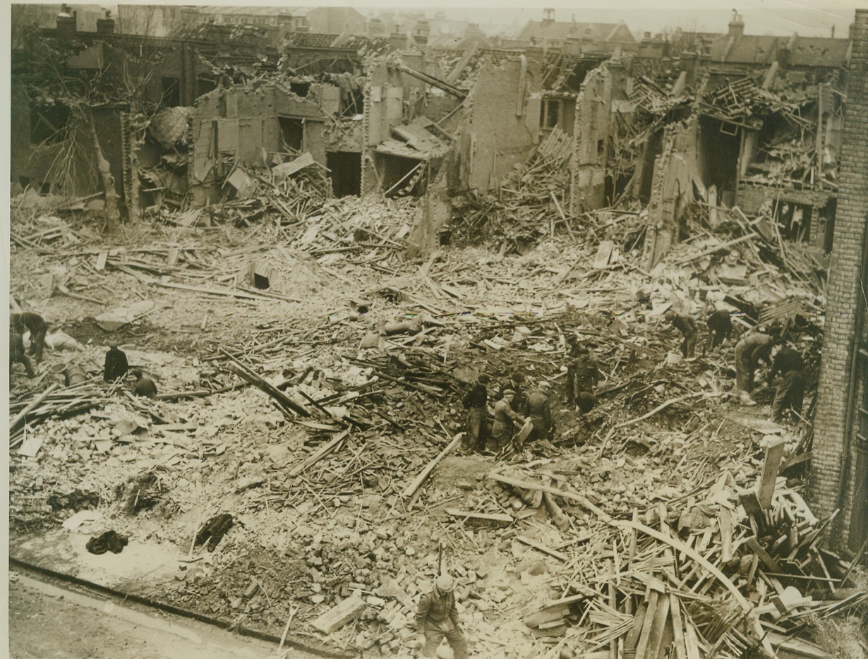 HUNTING FOR THOSE WHO WERE TRAPPED, 3/4/1944. LONDON – Rescue workers dig through great piles of bomb debris, hunting for trapped victims of a Nazi night raid over this residential section of London. Dropping incendiary and explosive bombs among the homes, the enemy raiders turned the district into a shambles. Credit: ACME;