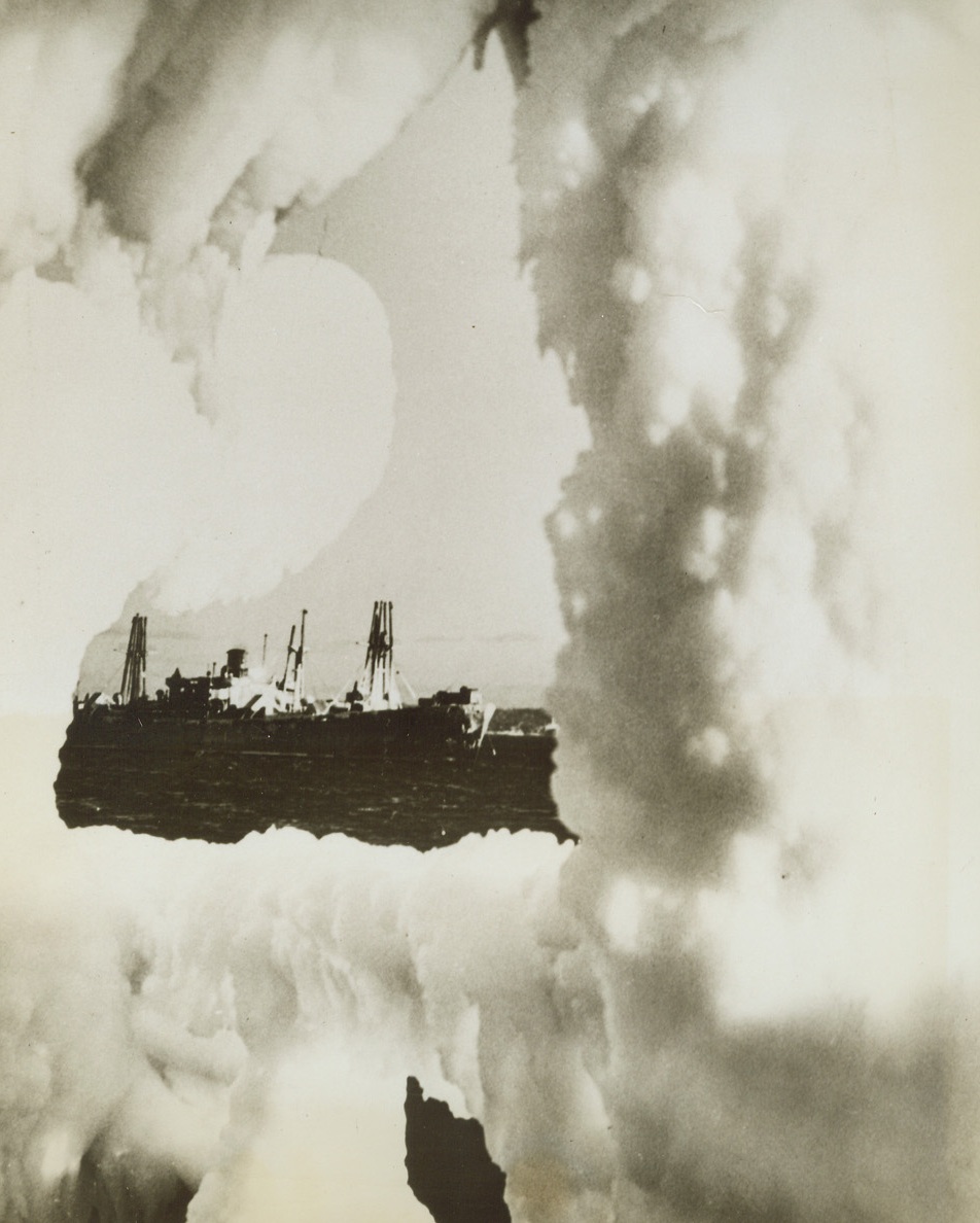 Ice-bound, 3/26/1944. NORTH ATLANTIC—A Royal Canadian Navy Corvette comes back from North Atlantic convoy escort duty heavily coated with ice. Disagreeable atmospheric conditions such as this indicates the struggle that goes on in the shipment of material and troops going overseas. The picture of the ice-free ship in the background was taken from the guard-rail of the ice-laden vessel.;