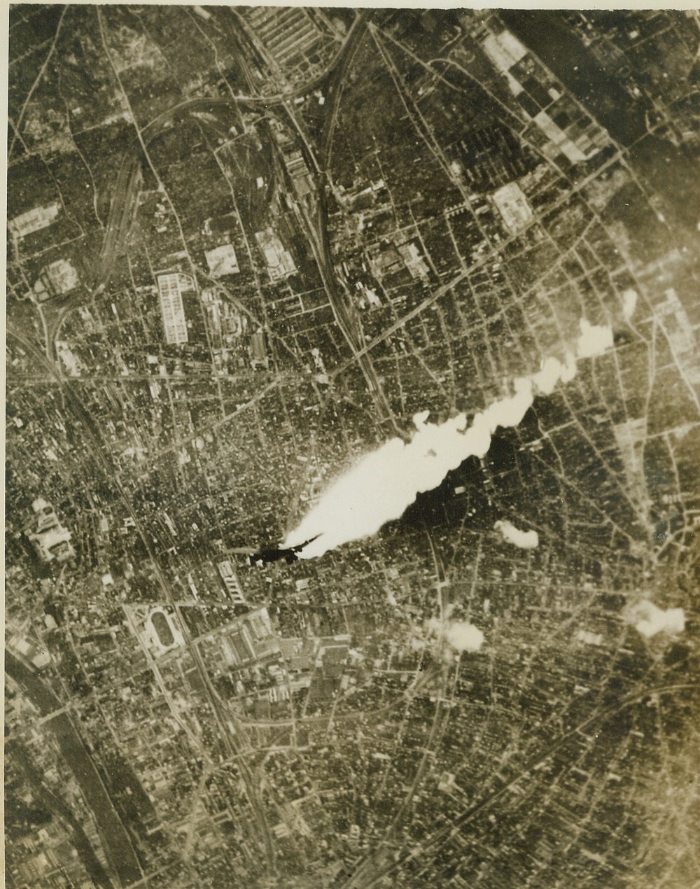 Death Dive of a Fortress, 3/6/1944. With a 400-foot streamer of white-hot flame trailing from its right wing, an American Flying Fortress hit by German flak over Paris, dives to its doom in the streets of the city below. Credit: (U.S. Army Air Forces Photo from ACME);