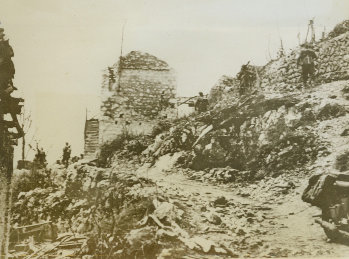 Into Ruined Cassino, 3/20/1944. Allied troops press forward on the outskirts of the flattened city of Cassino, Italy, smashing against stubborn resistance put up by German paratroopers landed in Cassino after Allied aircraft had bombed the city in the heaviest “obliteration raid” of the war. Although New Zealand troops today captured the Continental Hotel, bulwark of Nazi resistance, fierce fighting continues in the southern part of the city.Credit Line (Acme Photo via Army Radiotelephoto);