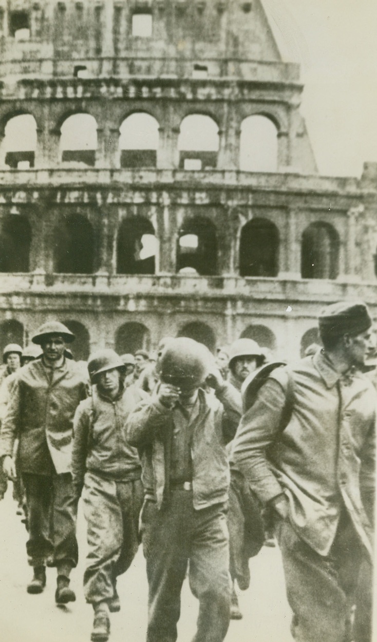ALLIED PRISONERS IN ROME—NAZIS SAY, 3/13/1944. ROME, ITALY—According to the German caption, this photo, from the Berlin Illustrieerte Beobachter, shows British and American prisoners captured during the Nettuno beachhead fighting marching through Rome. The ruins of the Colosseum are in the background. Credit: Acme;