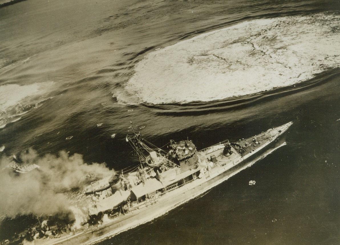 Marked for Davy Jones, 3/8/1944. This remarkably clear photo taken from a bomber of the U.S. Army 5th Air Force, and just released in the U.S., shows a Jap destroyer burning fiercely from a direct hit abaft the stack, just before Yank planes finished the warship off.  Only a few crew members can be seen on deck, as the bombers roared in for the attack, (two Japs are huddled just forward, and below the bridge).  The destroyer was one of 17 Nip vessels sunk.  In the American air attack off Mussau island, about 50 miles Northwest of New Ireland.  (this is the original of a radio photo serviced you previously). Credit line (USAAF photo from ACME);