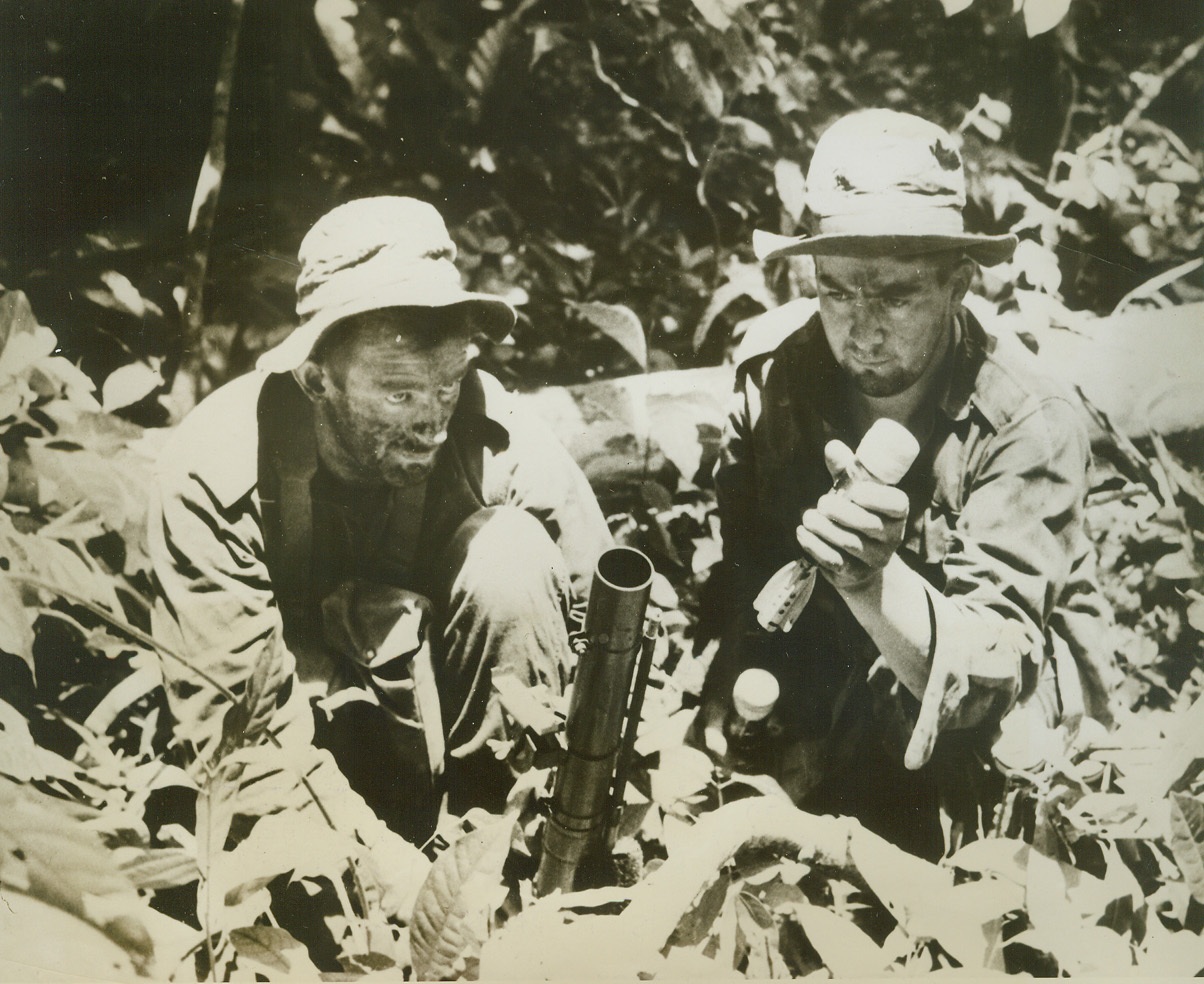 Jap-Busting on Green Island, 3/13/1944. Solomon Island – Two New Zealanders, Fred Mazengarb (left), of Gisborne, N.Z.; and William Elmiger, of Tearoha, N.Z. get ready to lob a deadly mortar shell at the Japs on Green Island, after allied forces had landed on the island just North of Bougainville, last Feb. 16th. Credit line (U.S. Navy official photo from ACME);