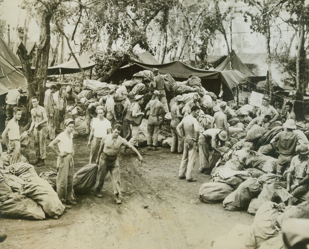 Mailman Comes to Gloucester, 3/12/1944. Cape Gloucester – Less than a week after the Marines hit the beach at Cape Gloucester, their mail arrived.  Here hundreds of sacks of the best morale builder in the world are sorted a short distance behind the enemy lines. Credit line (Official Marine Corps photo – ACME);