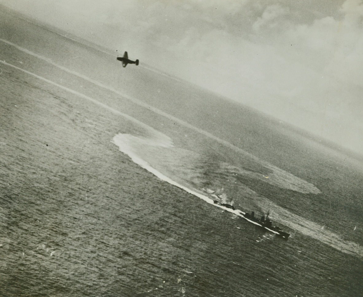 Headed For Disaster, 3/23/1944. Its after-section seemingly severed as a white comber roars over it scuppers, a damaged Japanese destroyer of the Asashio class vainly maneuvers in an attempt to escape the attack of a U.S. Navy Grumman Avenger (top, left), during the raid on Truk, last Feb. 16.  A short time later, the Nip warship joined the growing number of her sister ships at the bottom of the Pacific. Credit line (U.S. Navy photo from ACME);