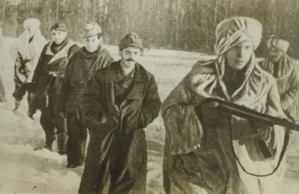 Red Army Takes Spanish Prisoners, 3/9/1944. On the Leningrad Front—White-robed Red Army fighters lead three of their newest prisoners of war back from the Soviet-Nazi fighting lines on the Leningrad front. The prisoners are Spanierds—probably members of Franco’s blue division which, this photo indicates, is still fighting with the Nazis on the Russian front. Credit: ACME radiophoto.;