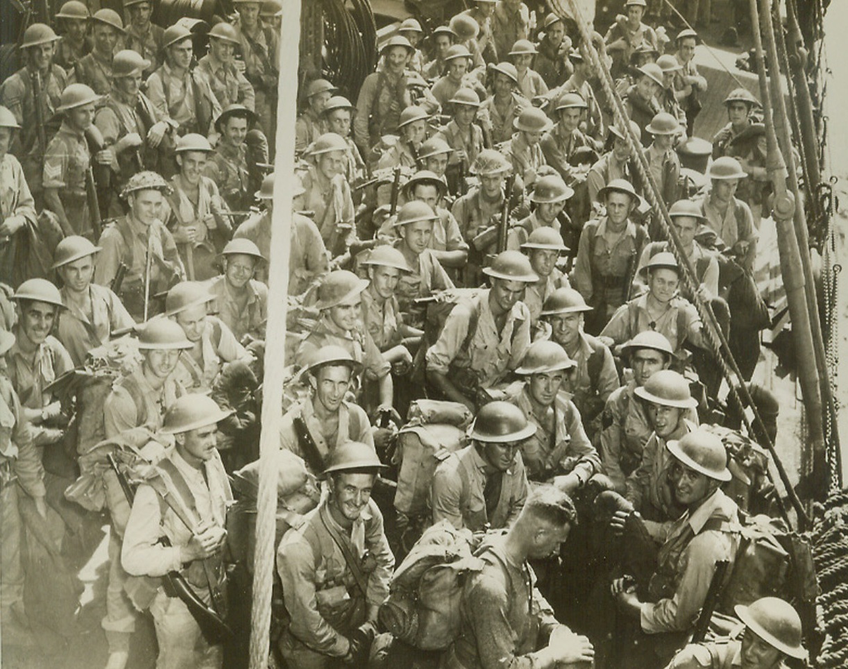 Ready to Go, 3/14/1944. Washington, D.C.: Troops of the British Empire, hardened veterans, stand on the deck of a U.S. Coast Guard-manned transport, waiting to go over the side in landing boats during invasion maneuvers. They will join the United Nations’ mounting attack power in the Pacific, in due time. Credit: U.S. Coast Guard photo from ACME.;