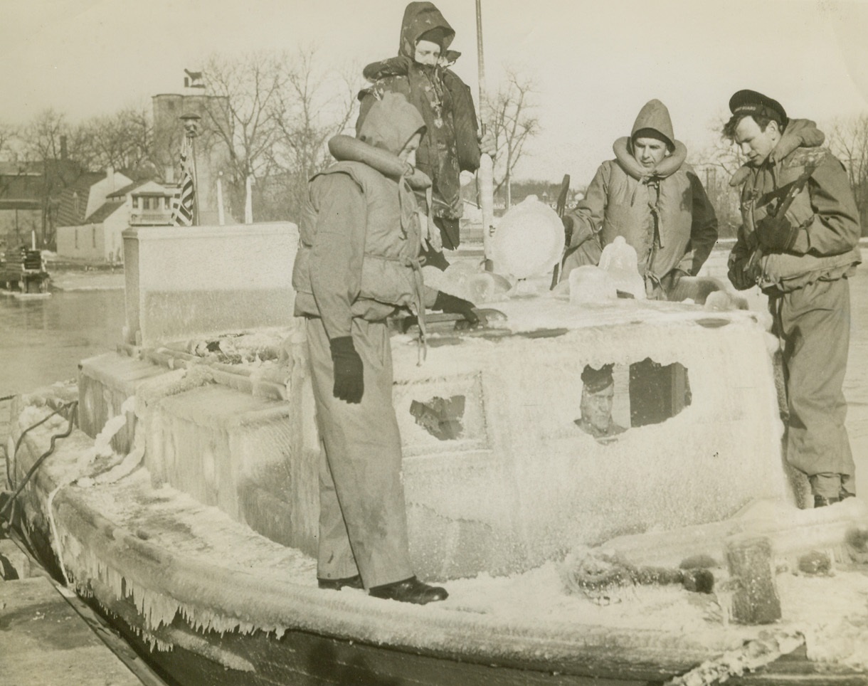 Hoax Sends Out Lake Patrols, 3/9/1944. Waukegan, Ill.—Authorities are searching for the person calling himself “Col. Jones of the Civil Aeronautics Patrol” whose telephone call reporting a tanker in distress off Waukegan sent 14 Coast Guard boats from the Lake Michigan stations into freezing weather and a rough sea. CAP has no such person on its lists and no sinking tanker was discovered. Crew of this ice-covered picket boat which returned to its Waukegan base includes: Noble Baker, Birmingham, Ala.; (left) L.F. Baker, Tekemah, Neb.; Anthony Enos, Waukegan, Ill.; and Clarence A. Breska, Milwaukee. Credit: ACME.;