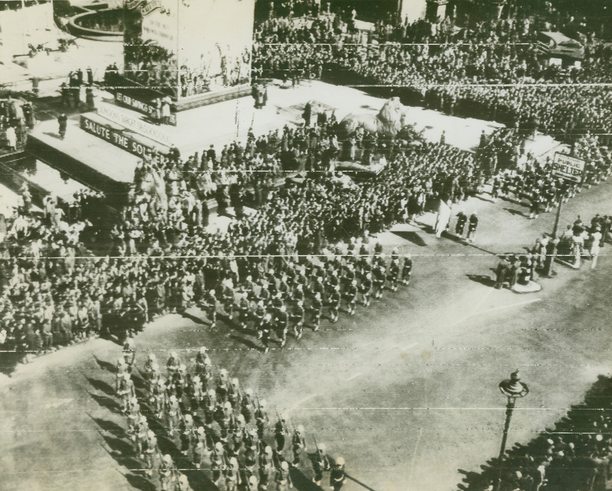 YANKS PARADE IN TRAFALGAR SQUARE, 3/30/1944. LONDON – Marching in the great parade to boost Britain’s current war bond drive today (March 30th), American warriors tramp past the reviewing stand in London’s Trafalgar Square.  American soldiers, WACs and mechanized equipment were in the parade, with men of the U.S. Army Air Forces getting the biggest hand as they marched by.  Photo radioed from London.Credit: Acme;